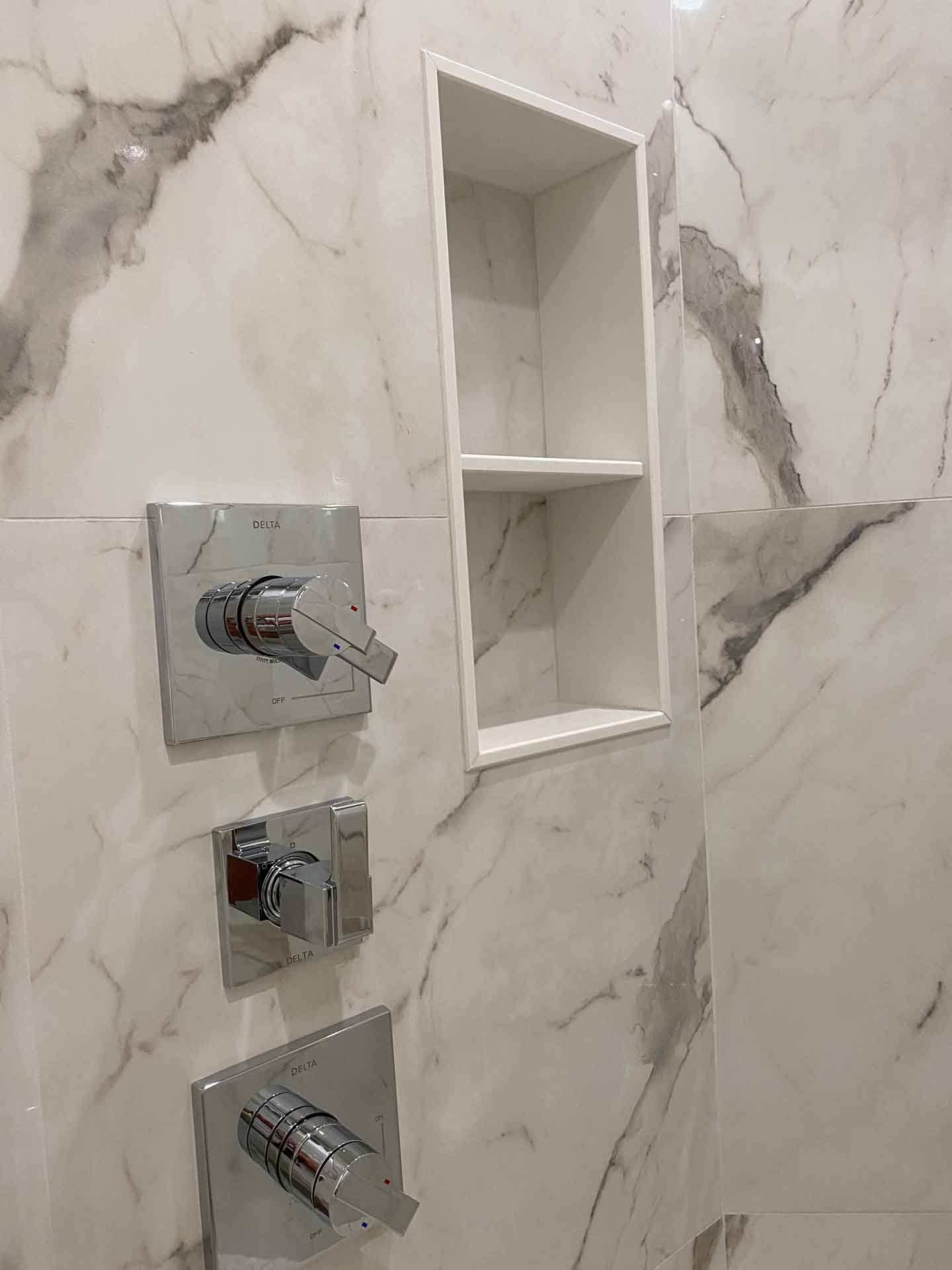 Newly renovated shower with inlaid shelf installed by Dream Space Renovation LLC