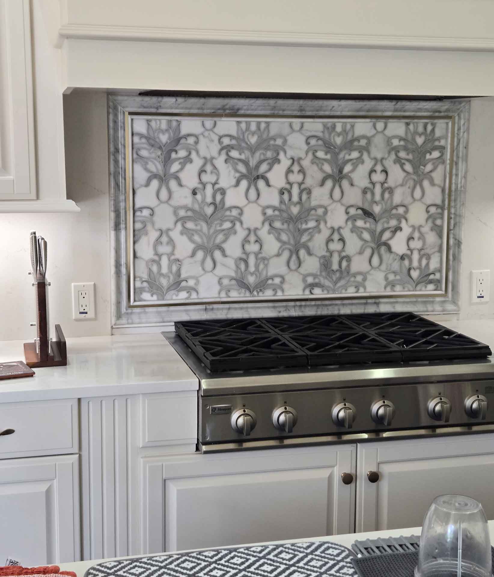 Gas cooktop with marble backsplash installed by Dream Space Renovation LLC